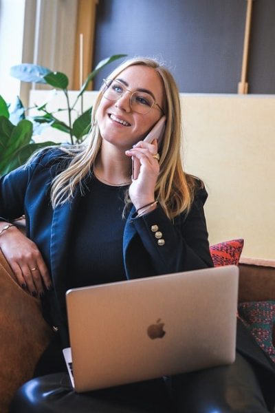 Woman working in office while talking on phone